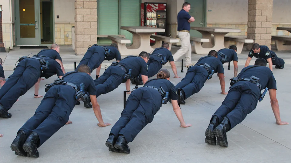 Police academy cadets doing push-ups during physical training